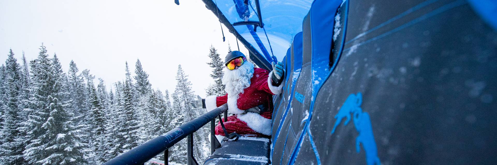 Santa Claus riding a chairlift | Christmas Events in Big Sky, Montana