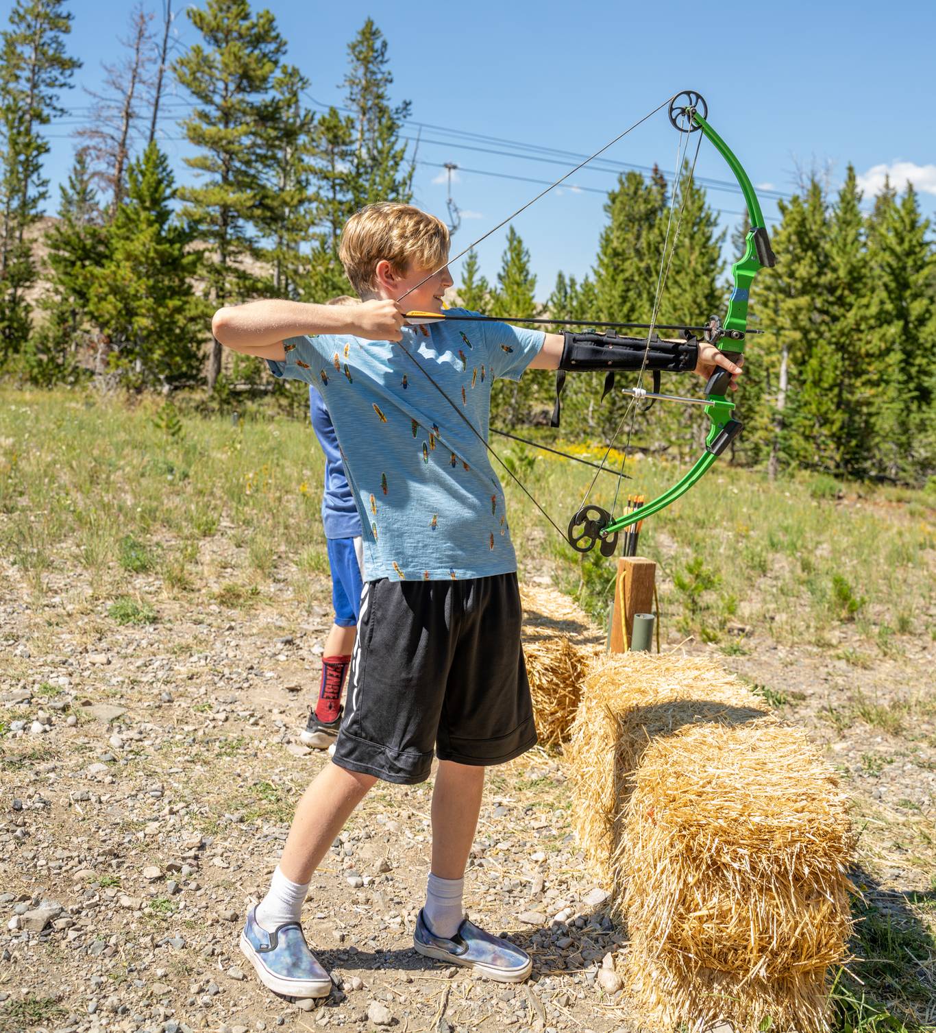 Child aiming a bow and arrow