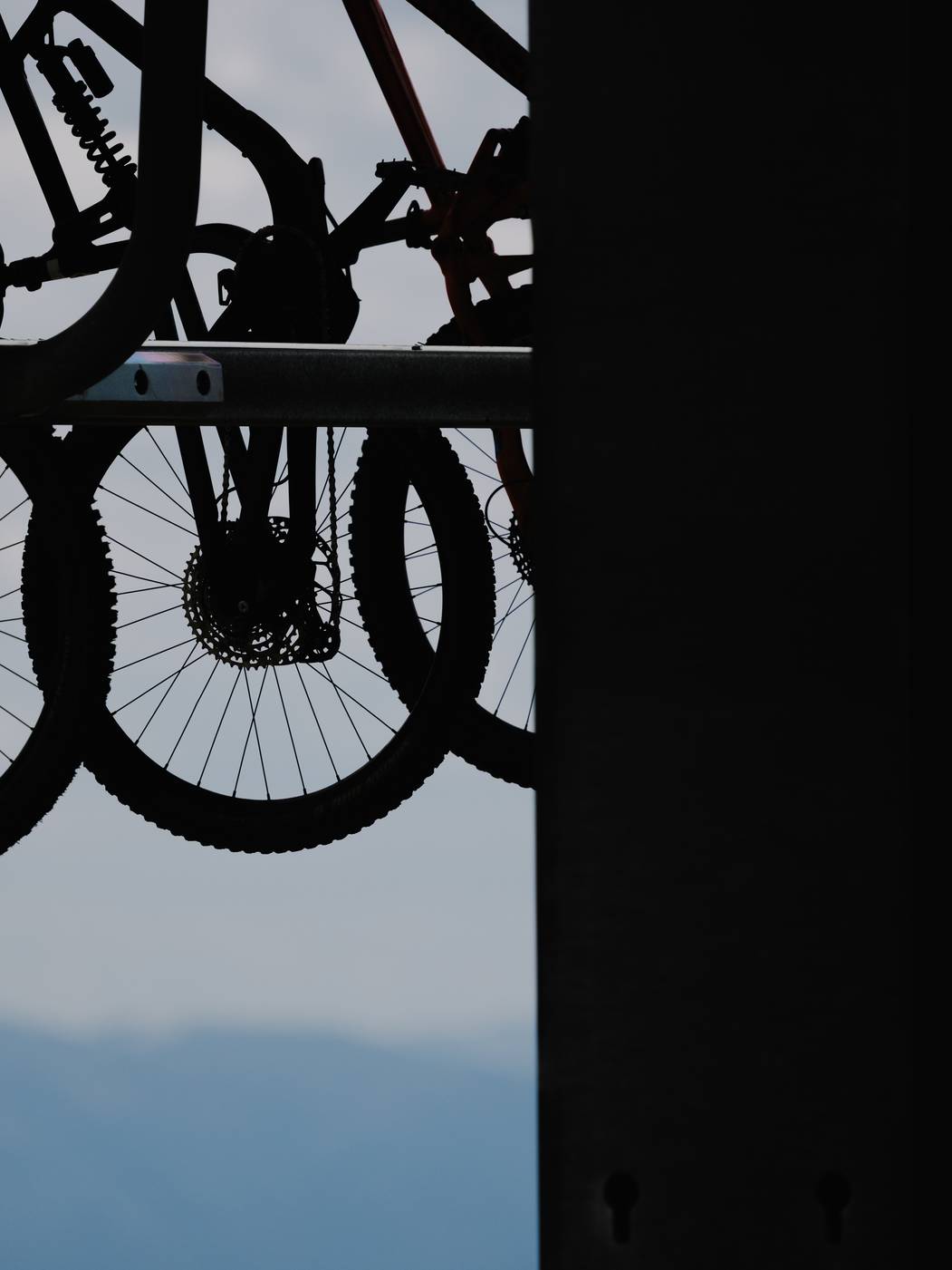 Bikes hanging from a chairlift bike carrier