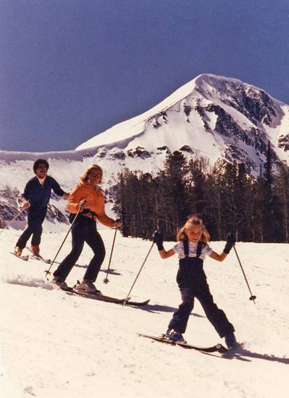 Family skiing with Lone Peak in background