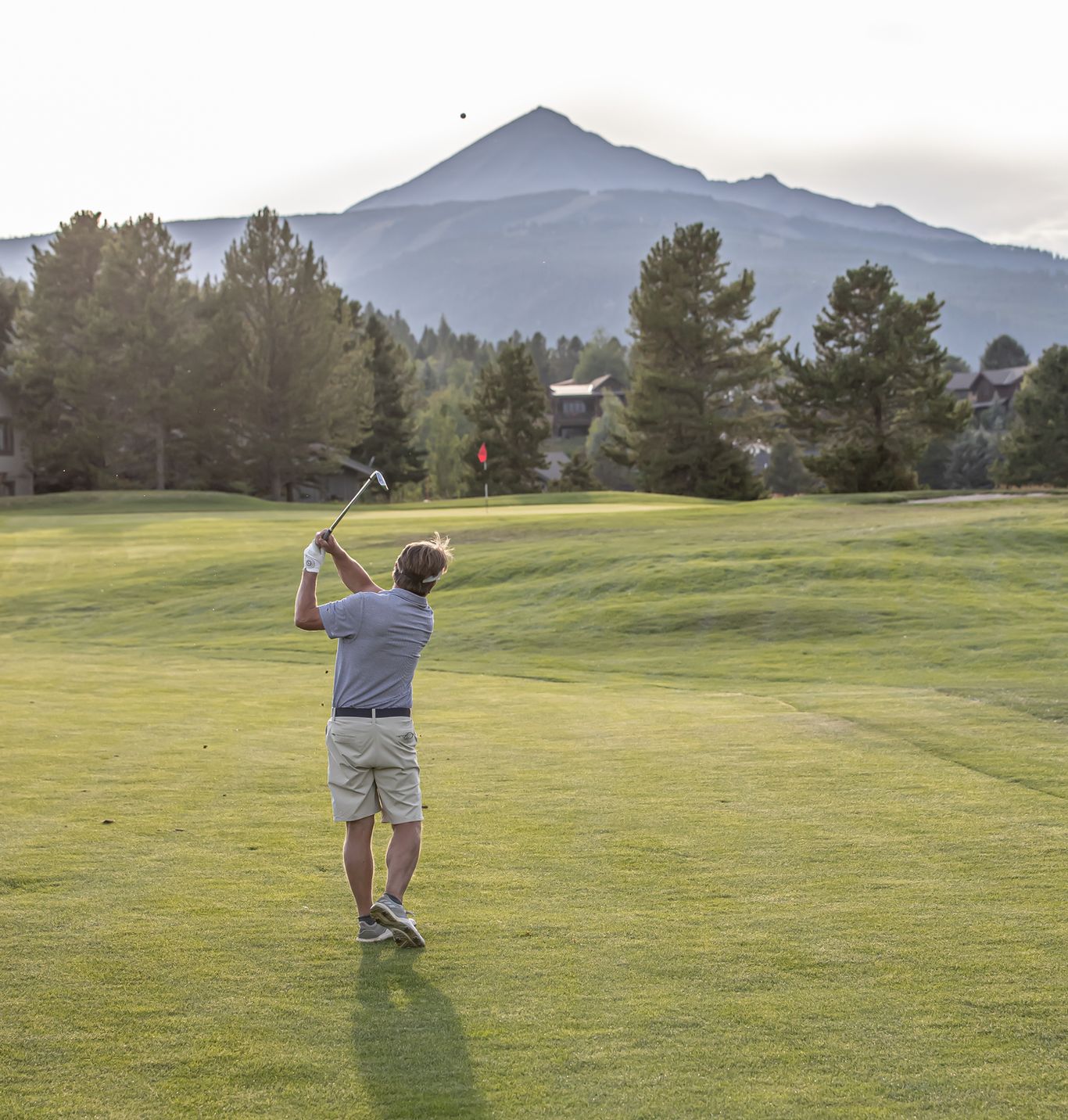 Golfer in front of Lone Mountain