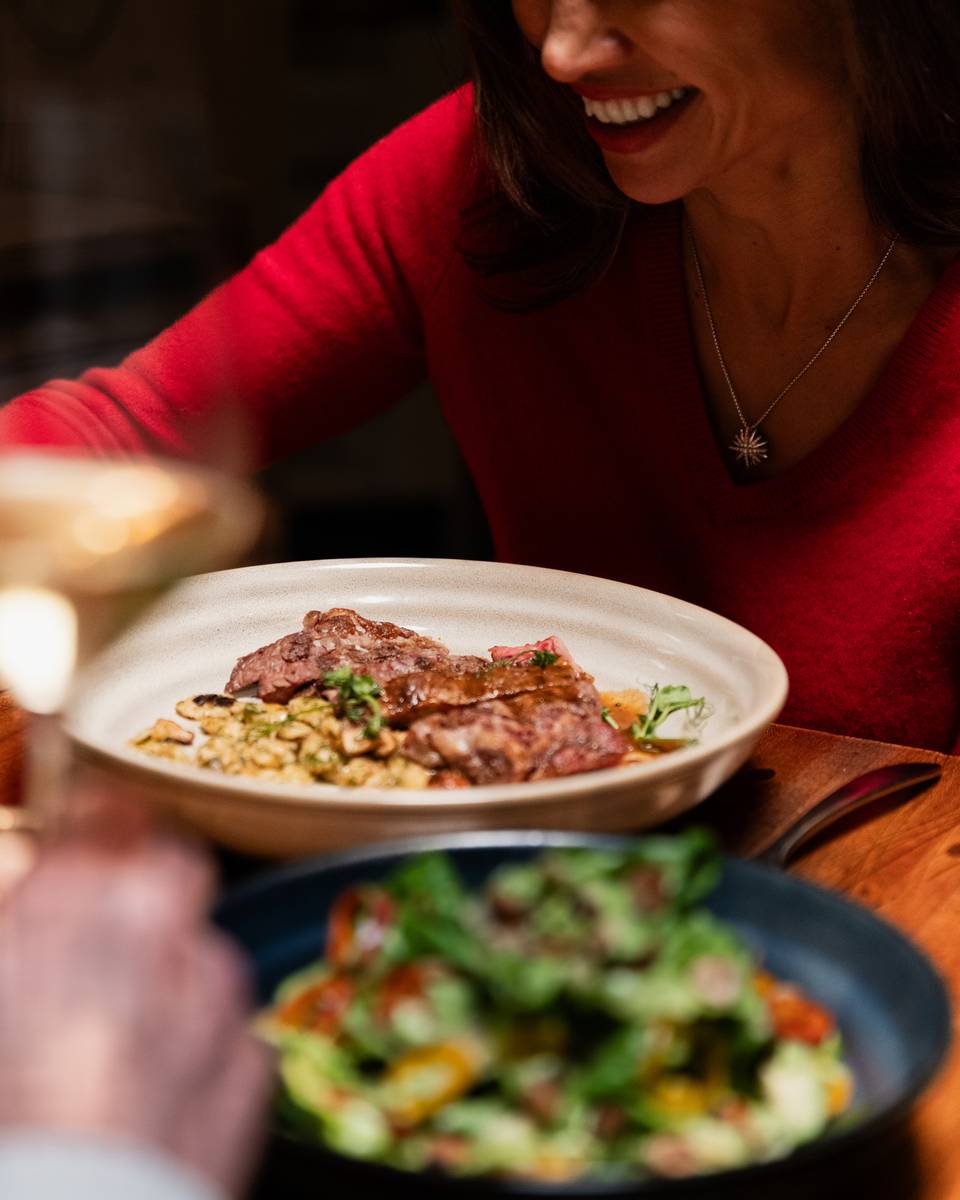 Woman smiling with plated dishes