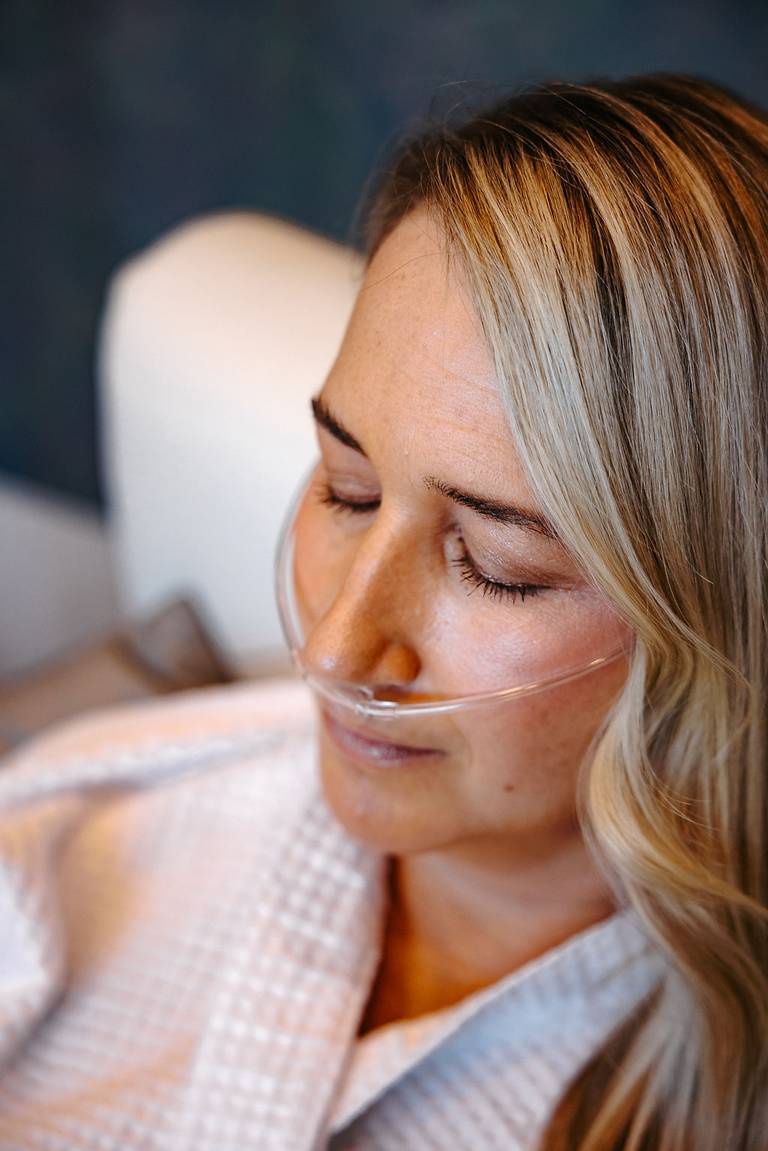 Woman with an oxygen supplement tube
