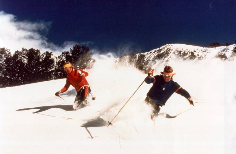 Two skiers enjoy powder at Big Sky Resort
