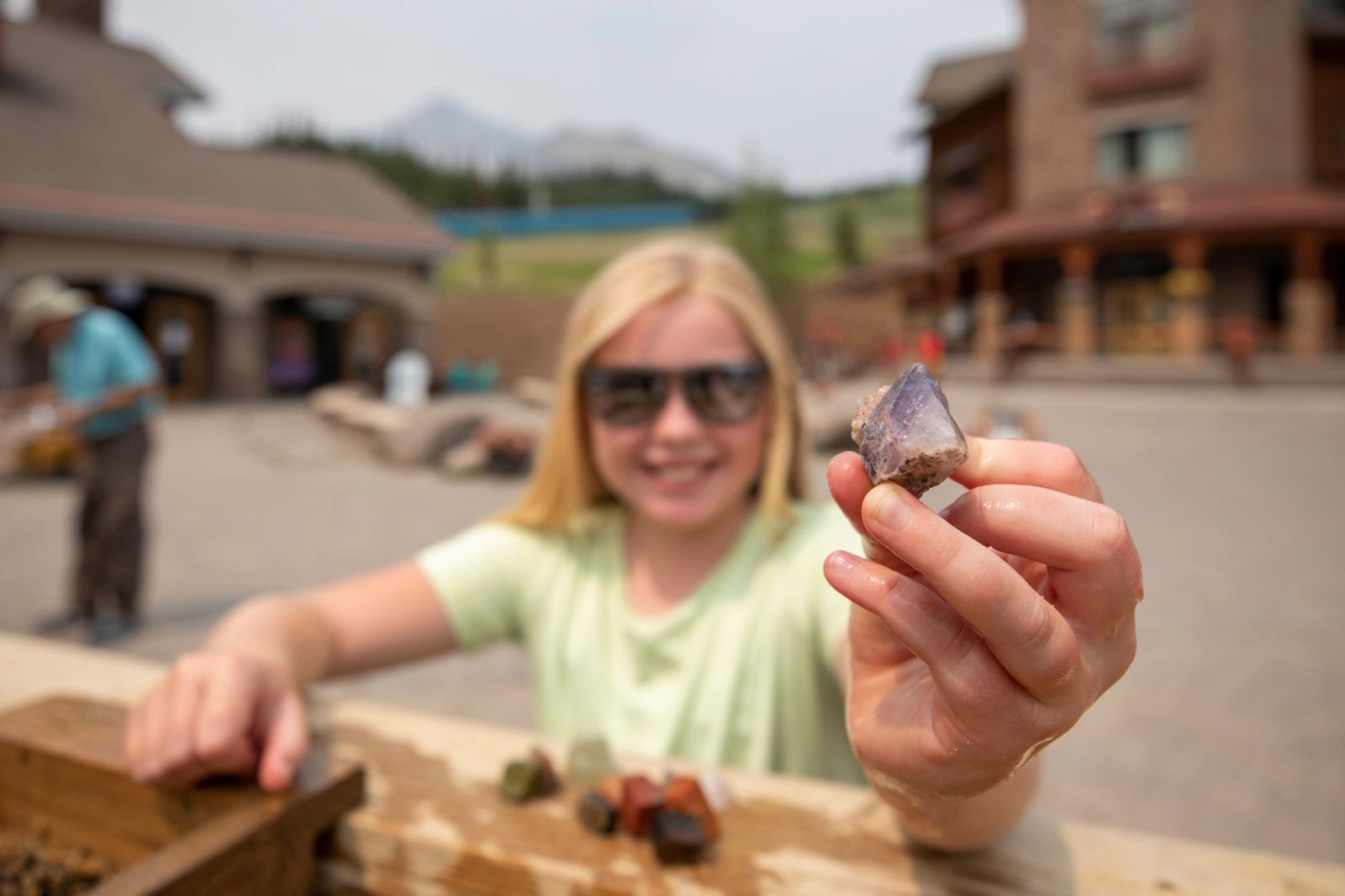 Girl holding up a gemstone