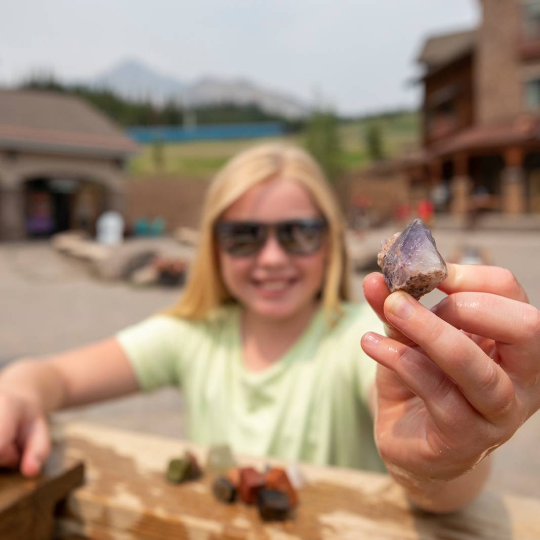 Girl holding up a gemstone