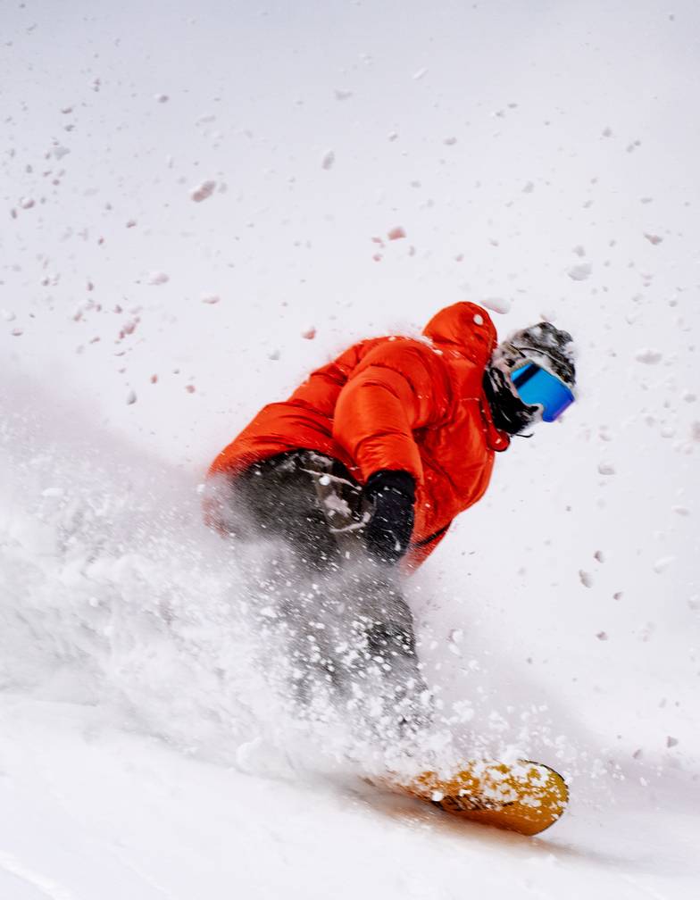 Snowboarder carving on Brighton powder day