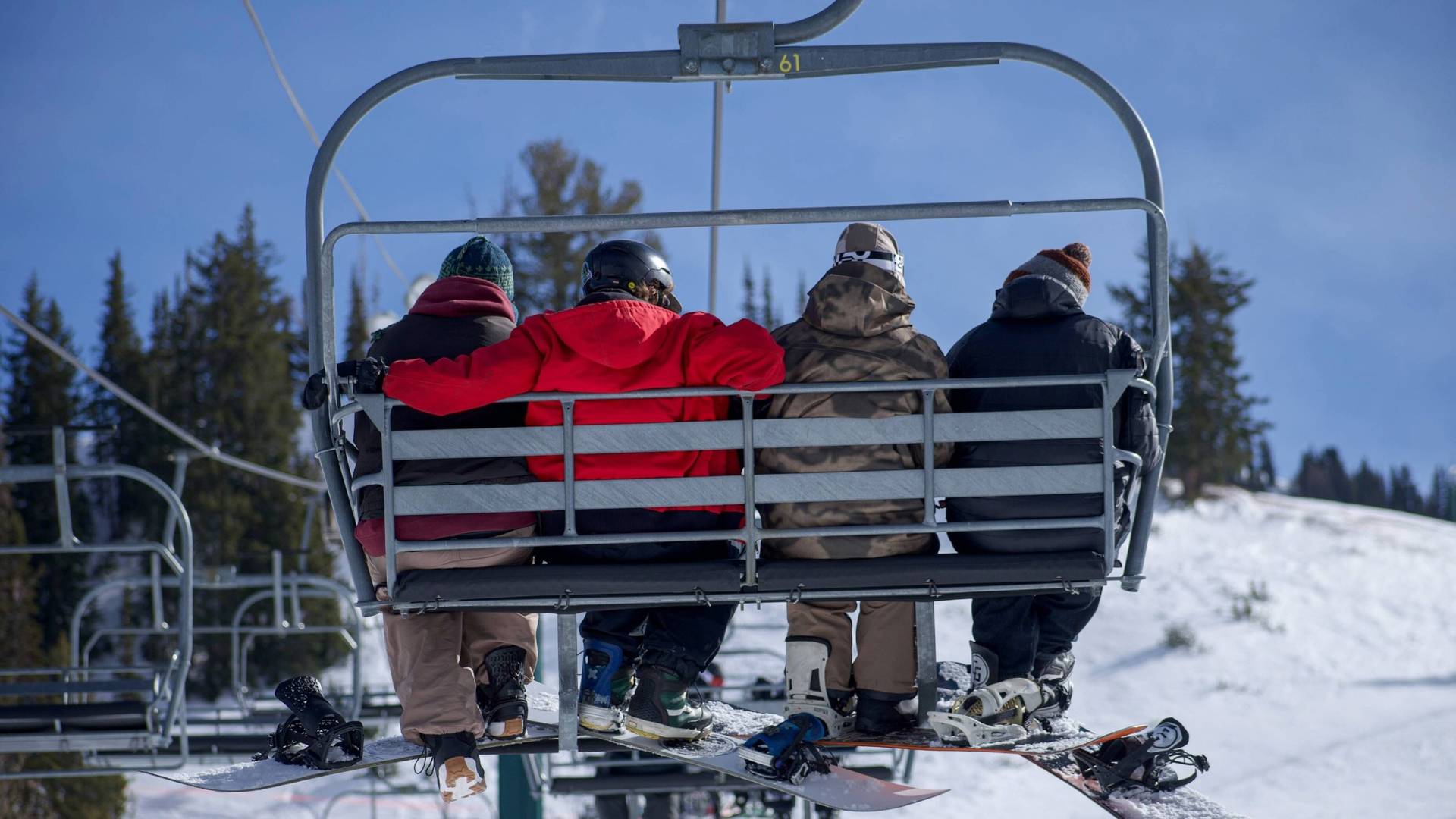 Snowboarder friends on a chairlift at Brighton Resort