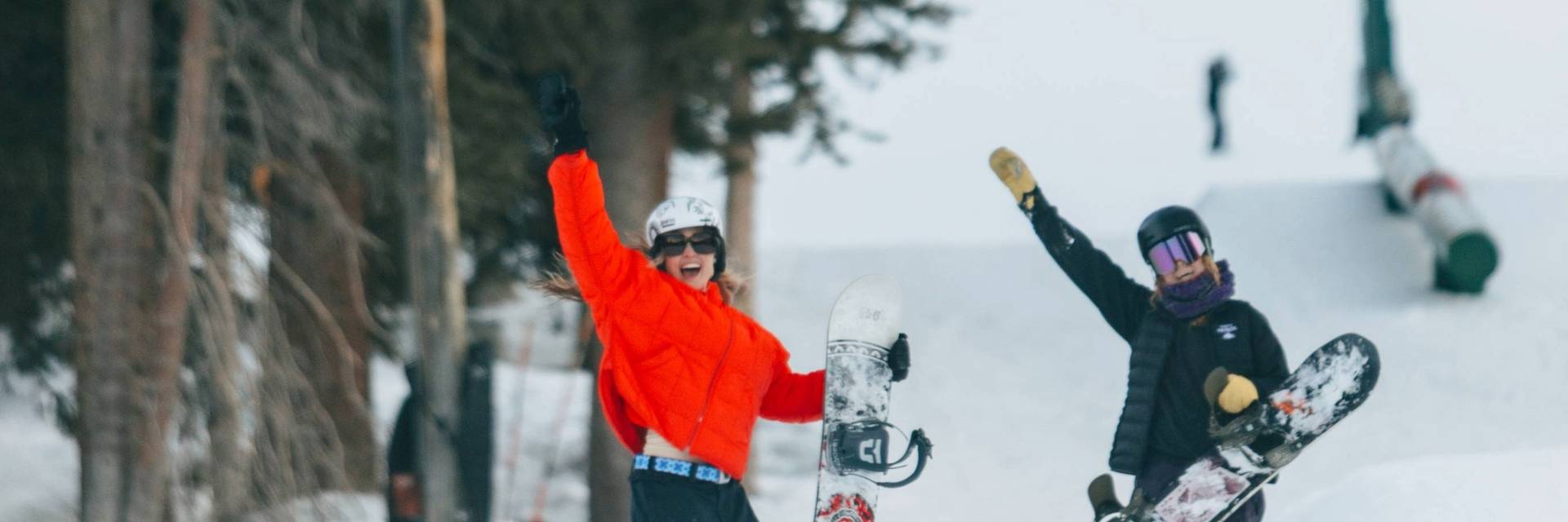 Snowboarder girl friends laughing at Brighton Ski Resort Utah