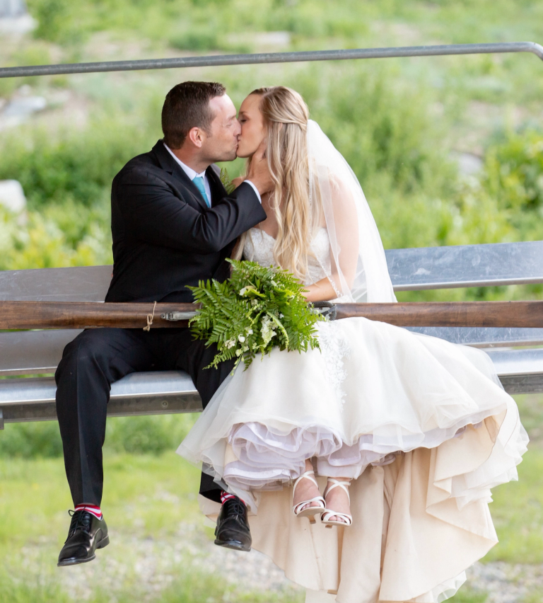 Couple sitting on Milly Express lift on their wedding day at Brighton Resort