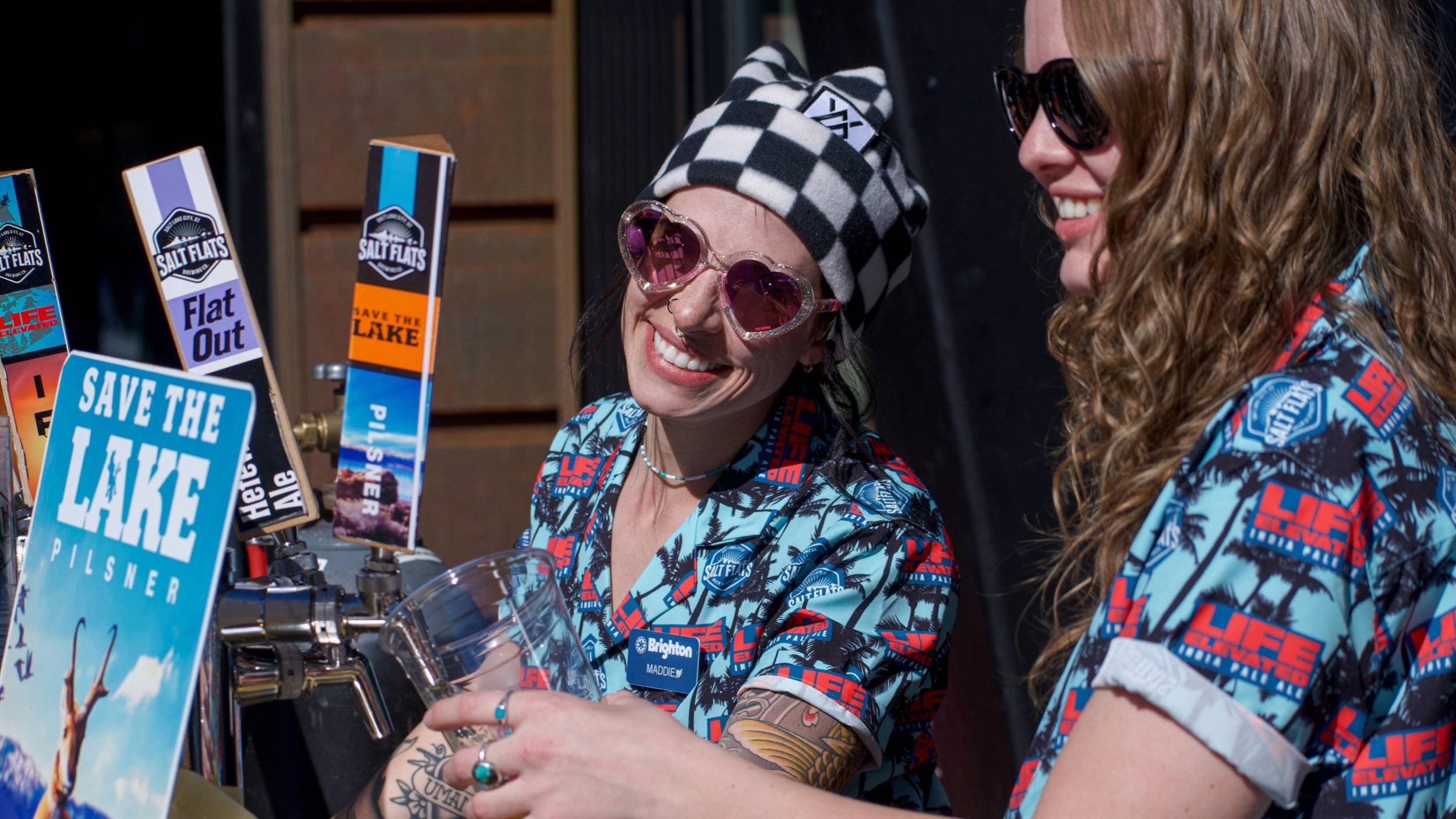 Brighton employees serving beer at the Sidwinder