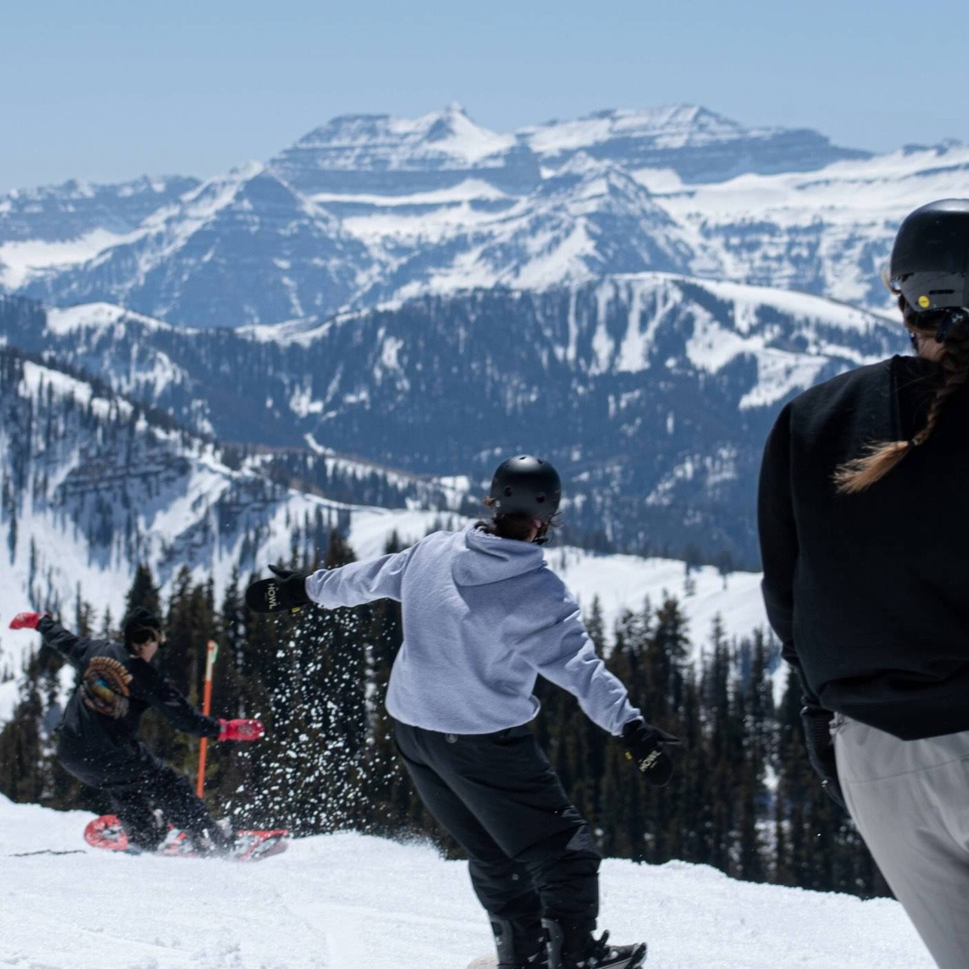 Snowboarders riding off Great Western at Brighton Resort