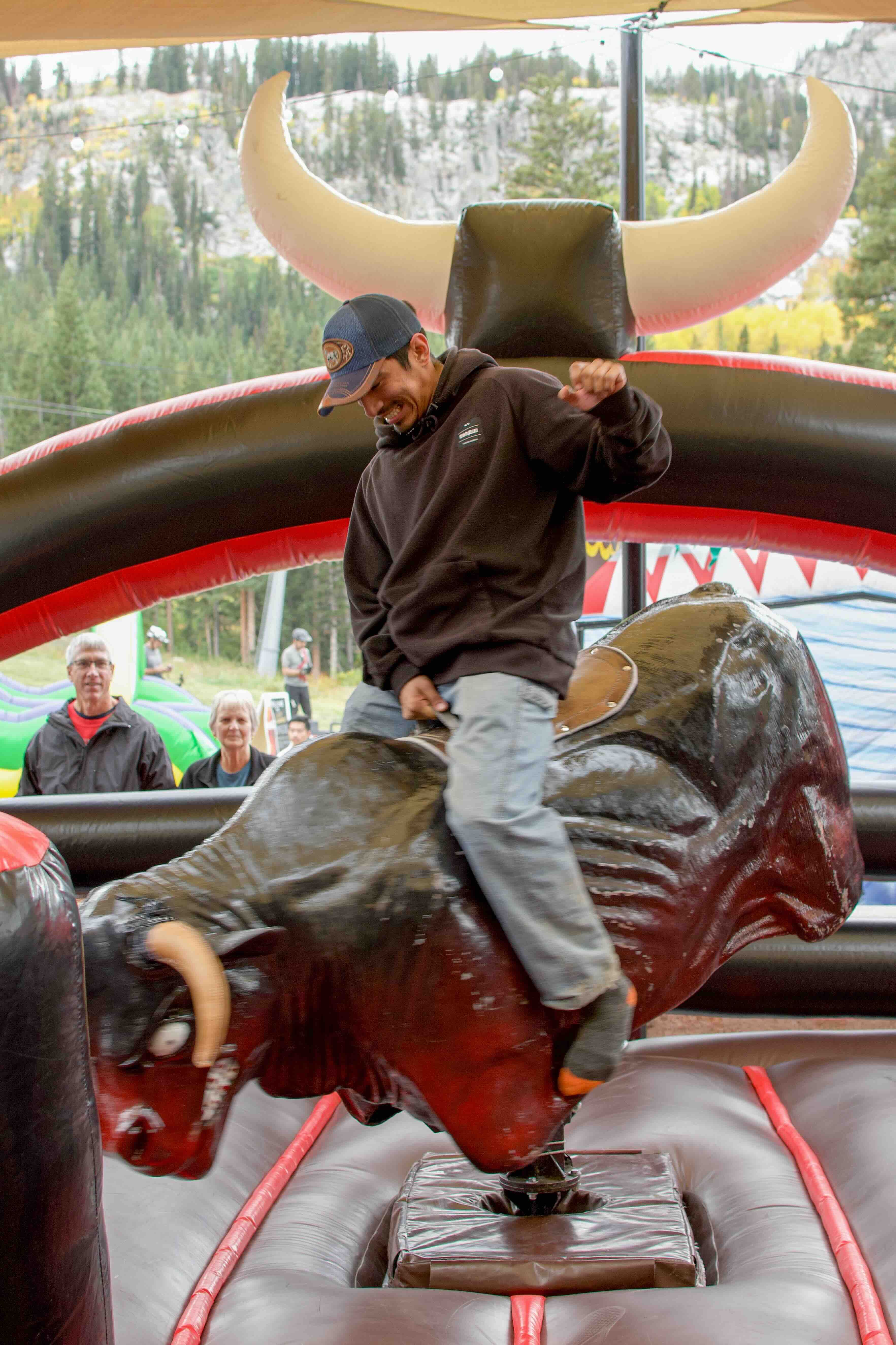 Riding mechanical bull at Brighton Resort in the summer