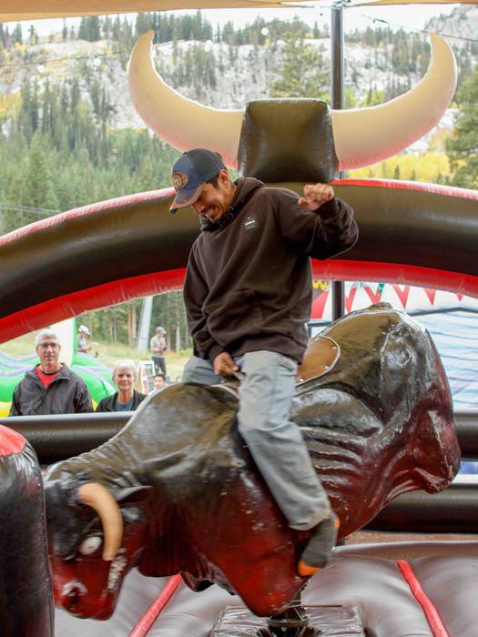 Riding mechanical bull at Brighton Resort in the summer