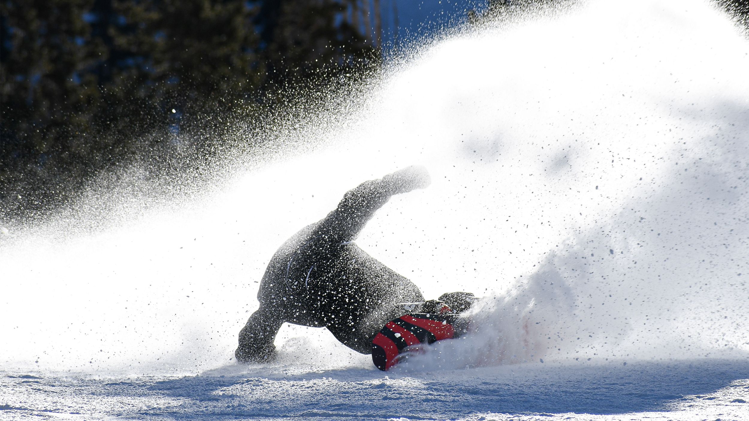 Snowboarder slashing on a groomer