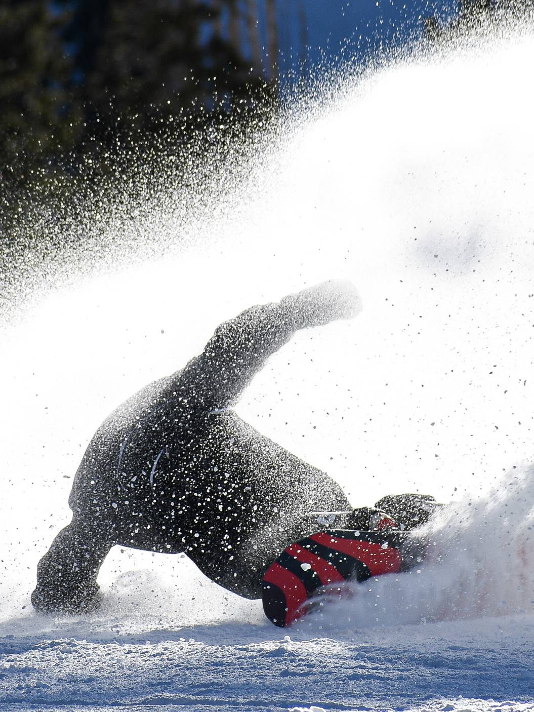 Snowboarder slashing on a groomer