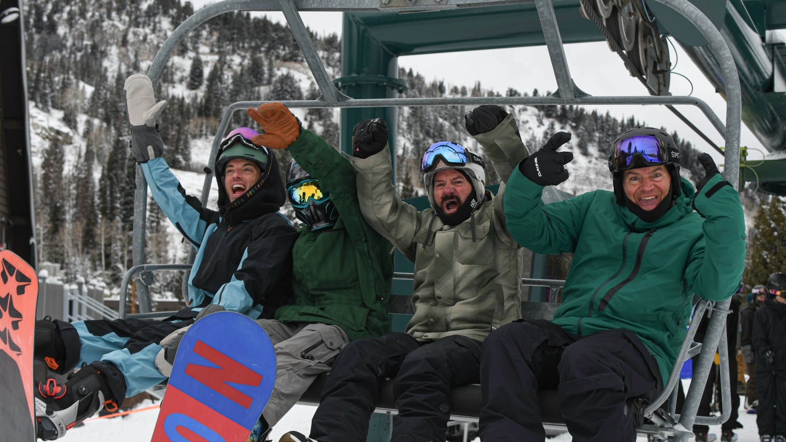 Happy snowboarders on chairlift at Brighton Resort