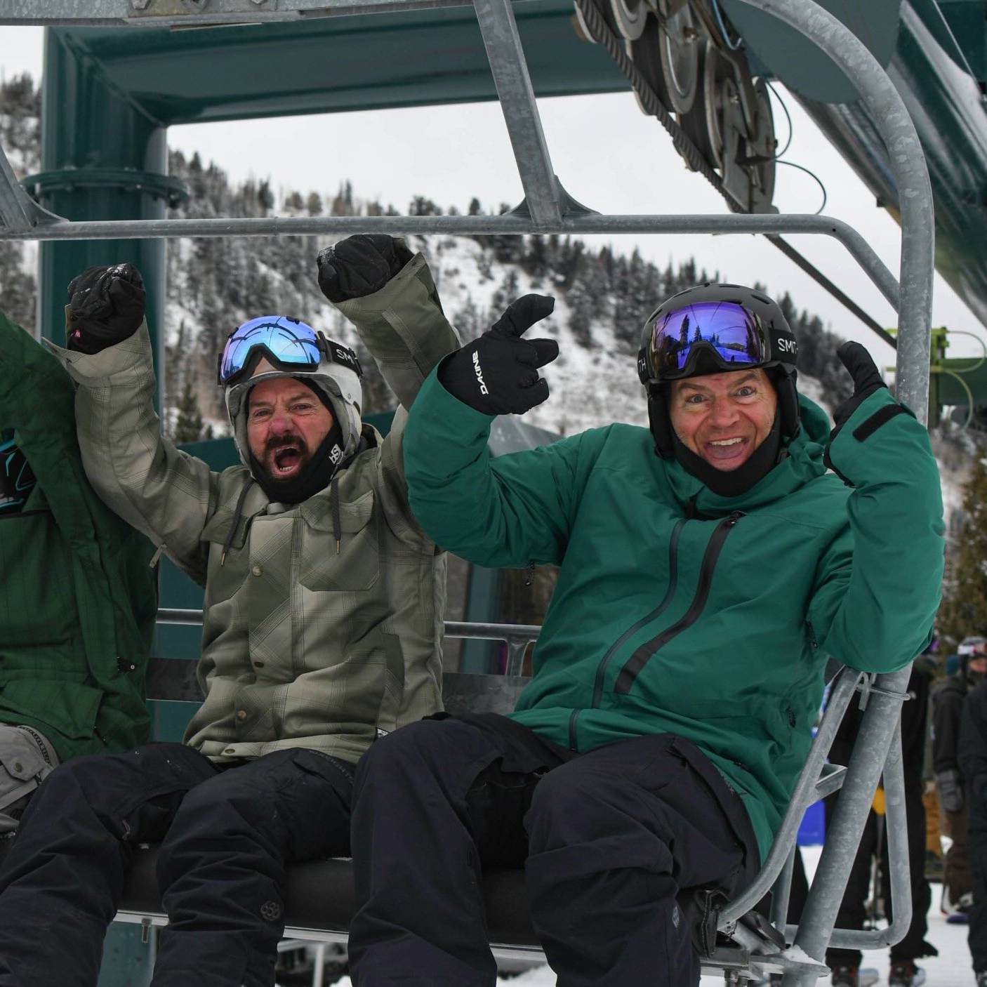 Happy snowboarders on chairlift at Brighton Resort