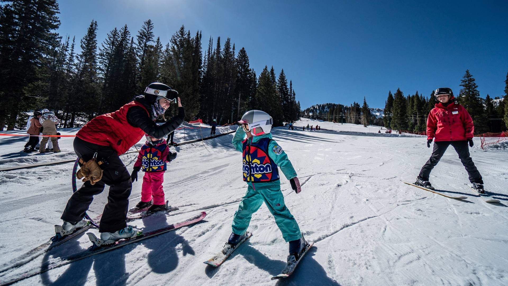 Ski school instructor with kid during lesson at Brighton Resort