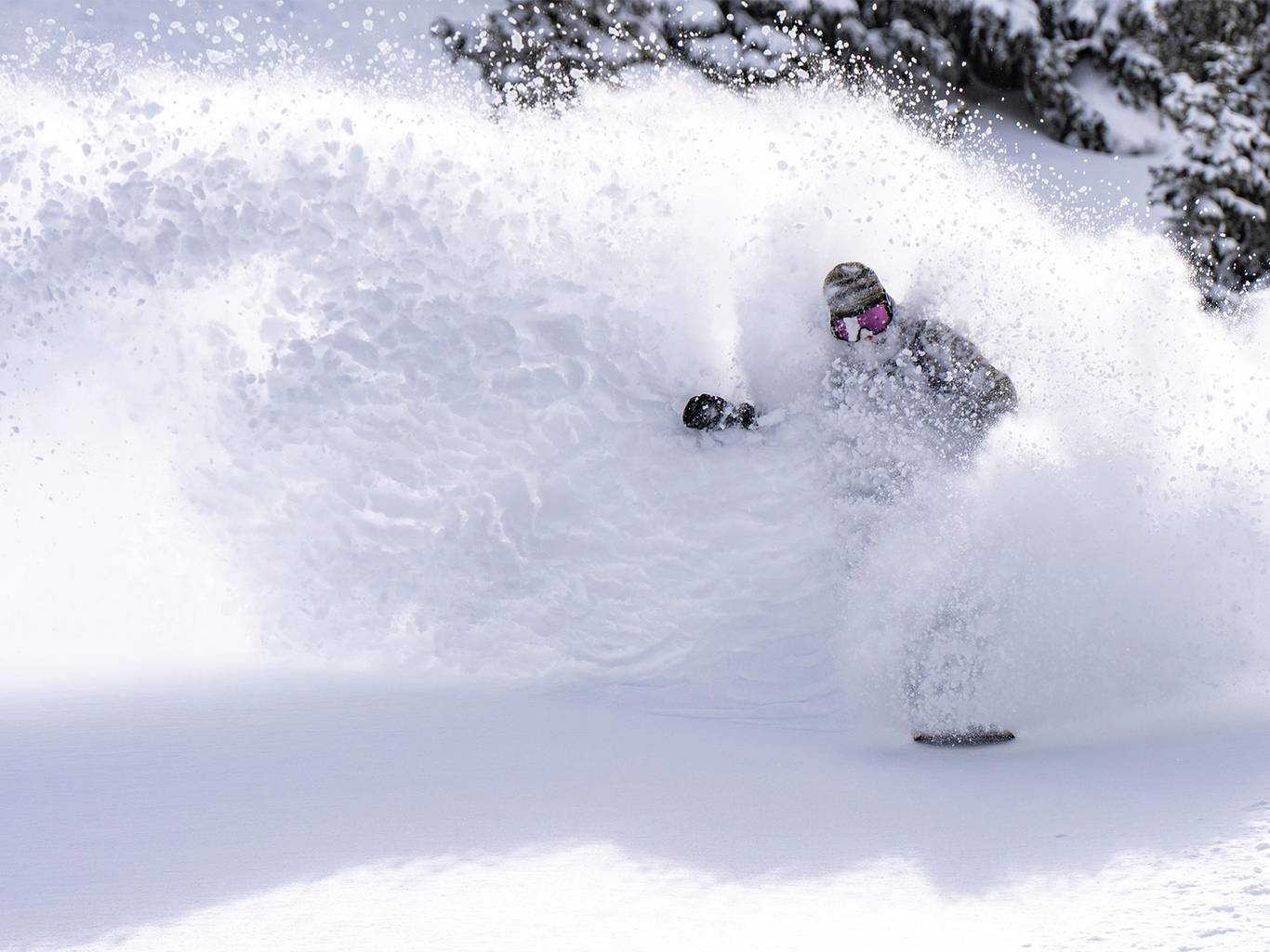 Snowboarder powder slashing