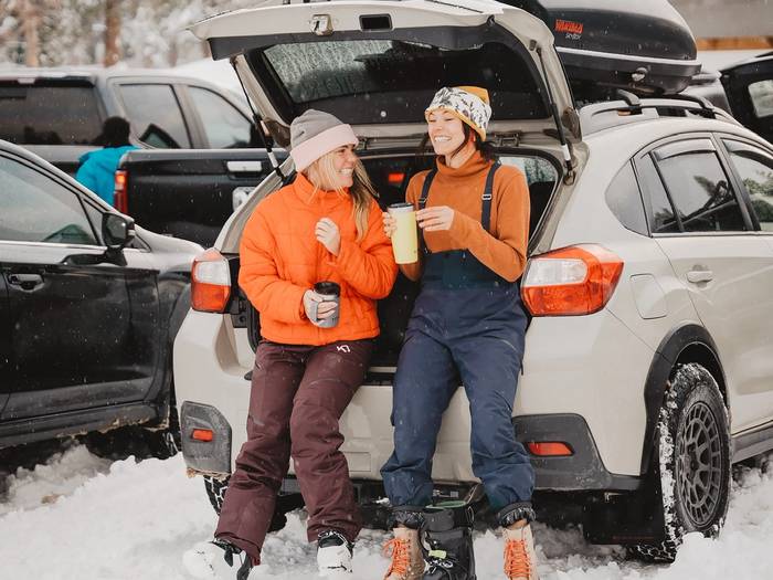 Friends laughing in the parking lot of Brighton Ski Resort