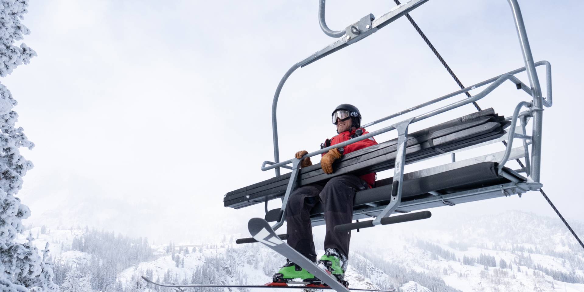 Skier on a chairlift at Brighton Resort, Utah