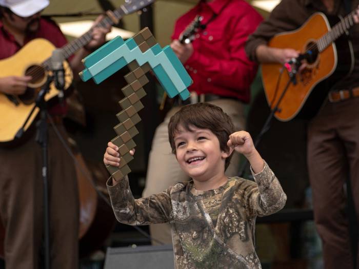 Kid dancing to live music at Brighton Resort in the summer time