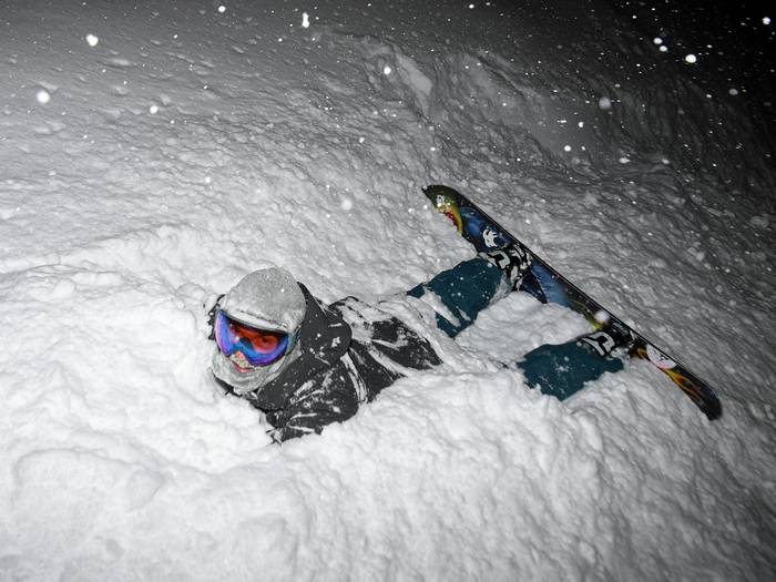 Snowboarder in deep snow while Night Riding at Brighton Resort