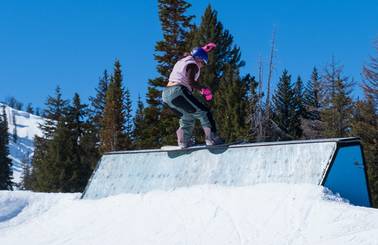 Snowboarder on The Bomb Hole wall at Brighton Resort