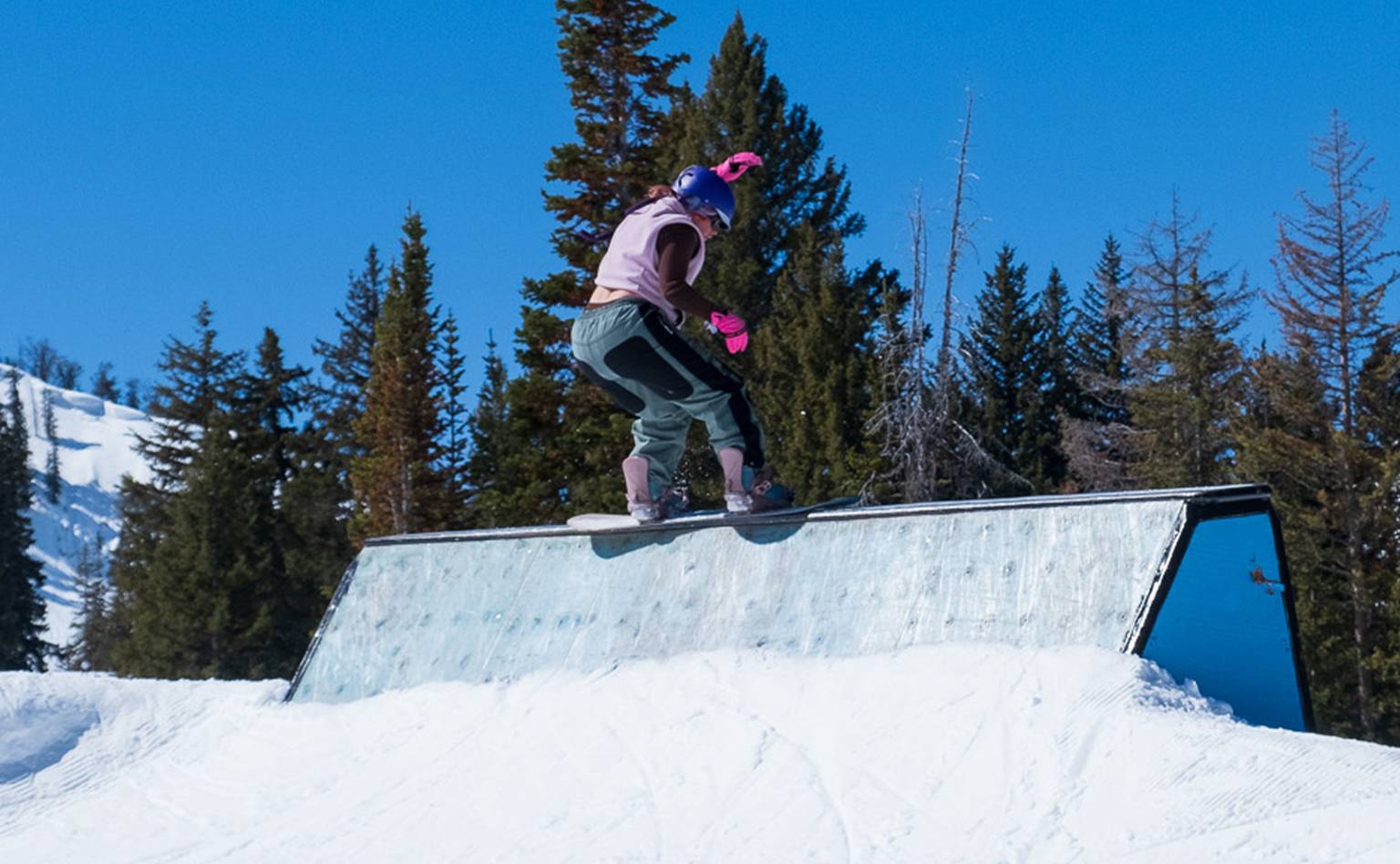 Snowboarder on The Bomb Hole wall at Brighton Resort