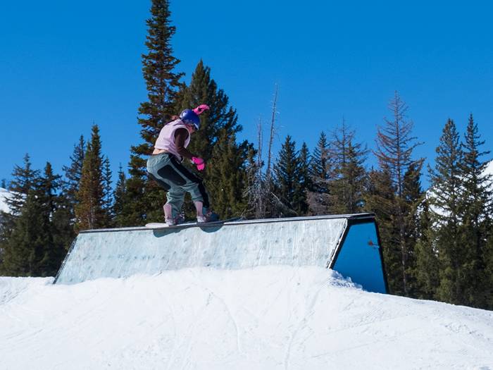 Snowboarder riding Candyland rail