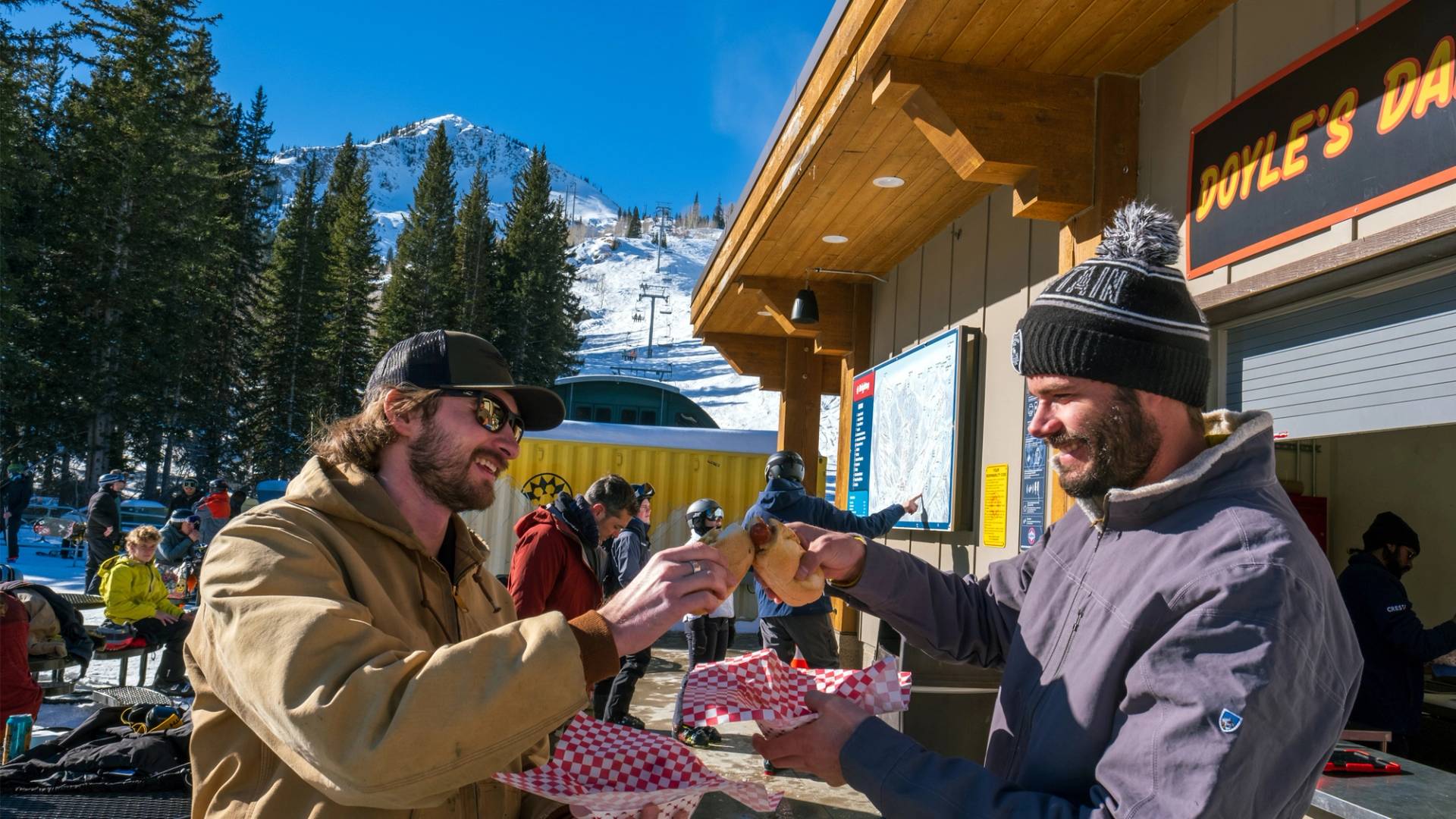 Friends eating at Doyle's Dawgs at Brighton Ski Resort in Utah