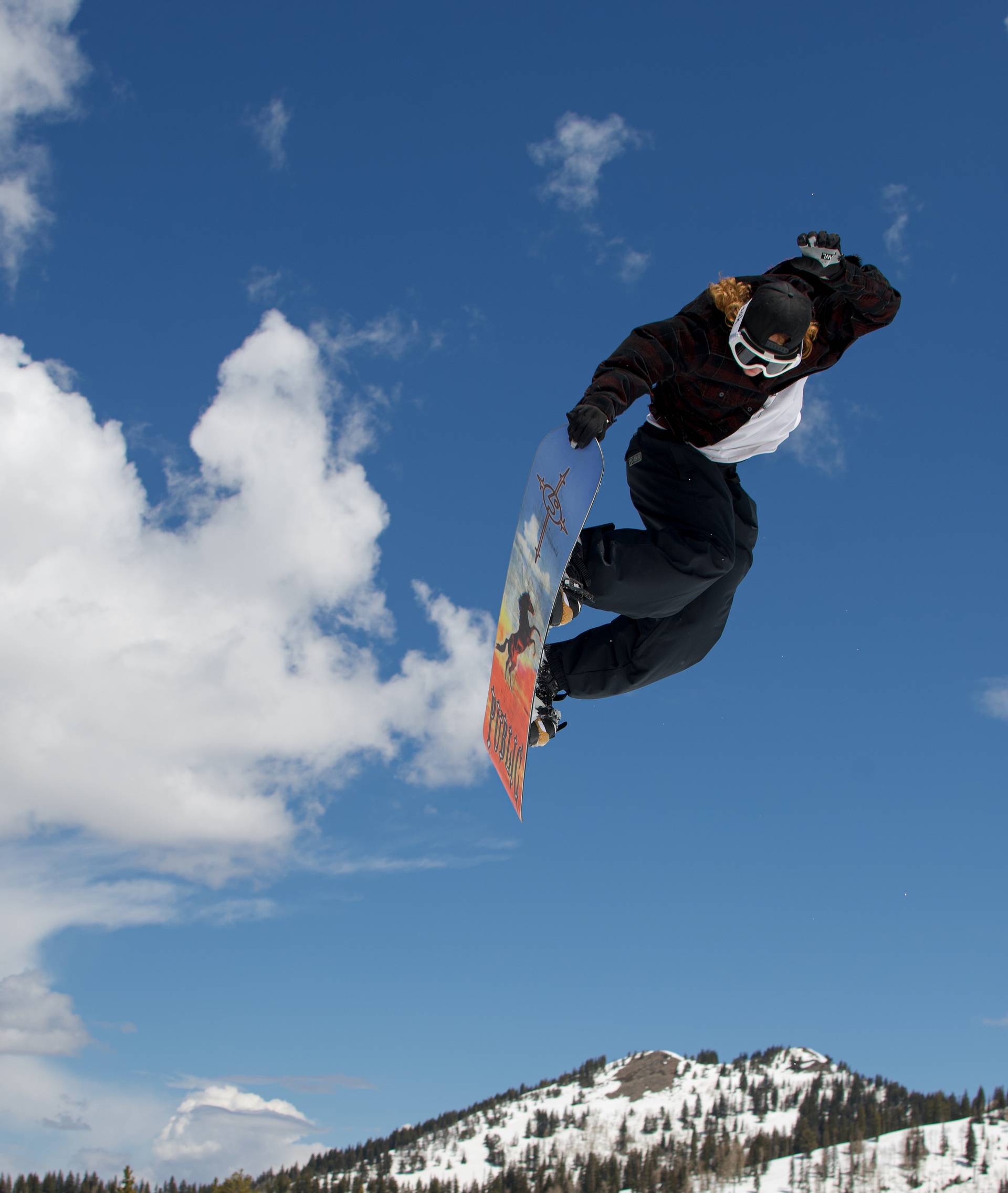 Snowboarder during mid jump at Brighton Resort's Meltdown