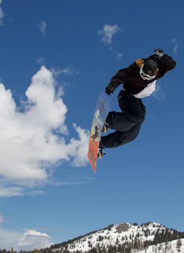 Snowboarder during mid jump at Brighton Resort's Meltdown