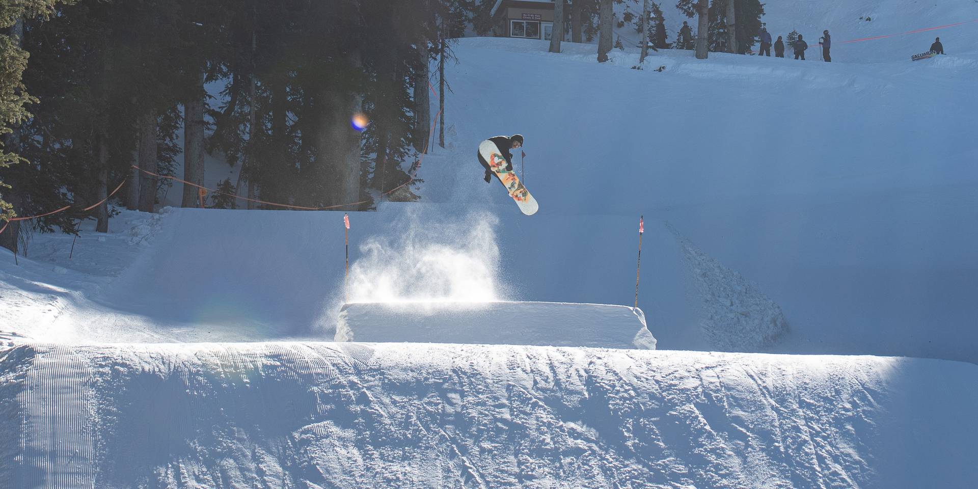 Snowboarder going off My Oh My jump