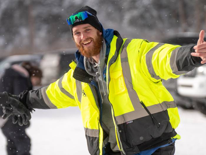 Parking lot employee smiling