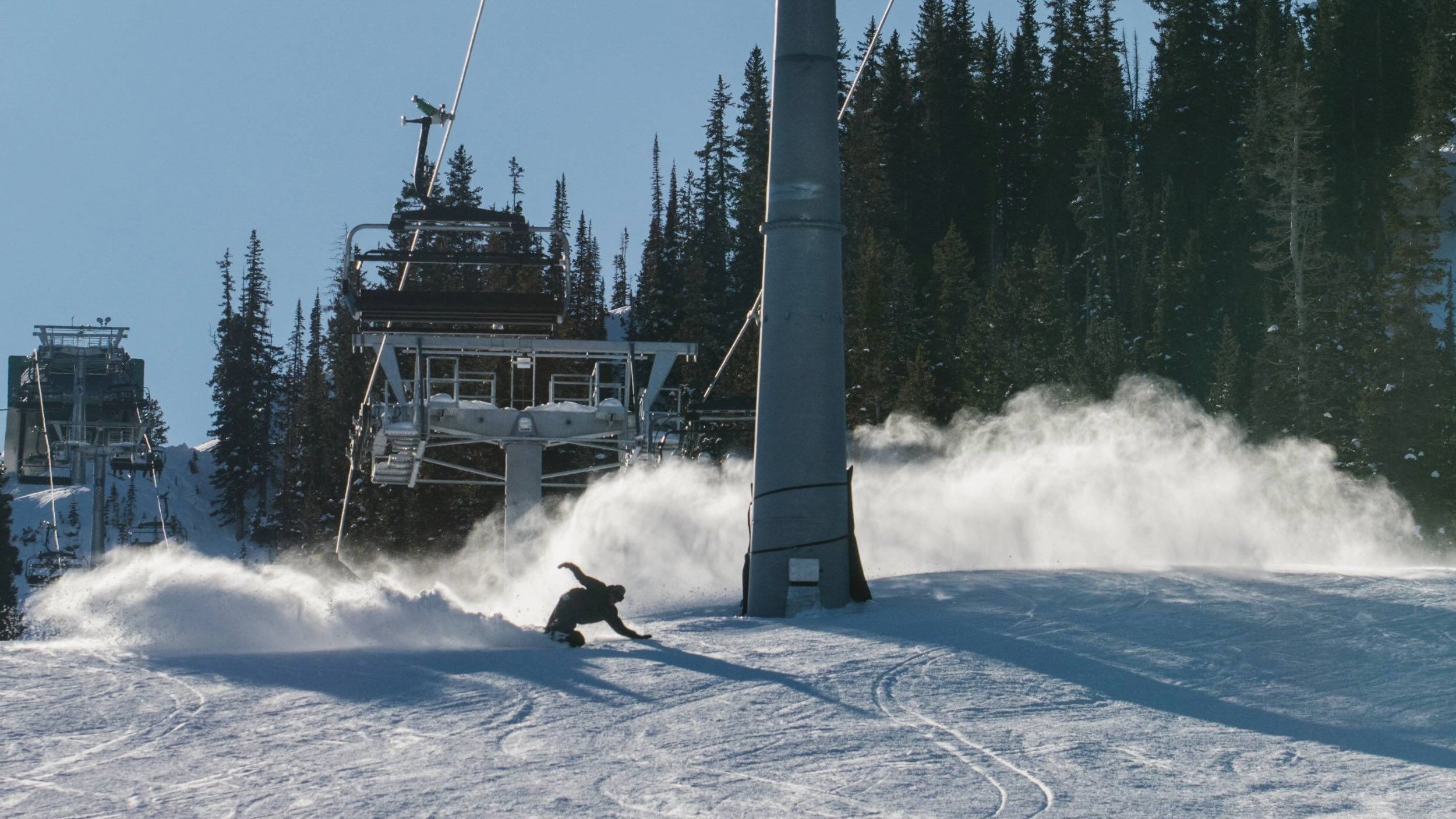 Snowboarder riding down Crest at Brighton Ski Resort