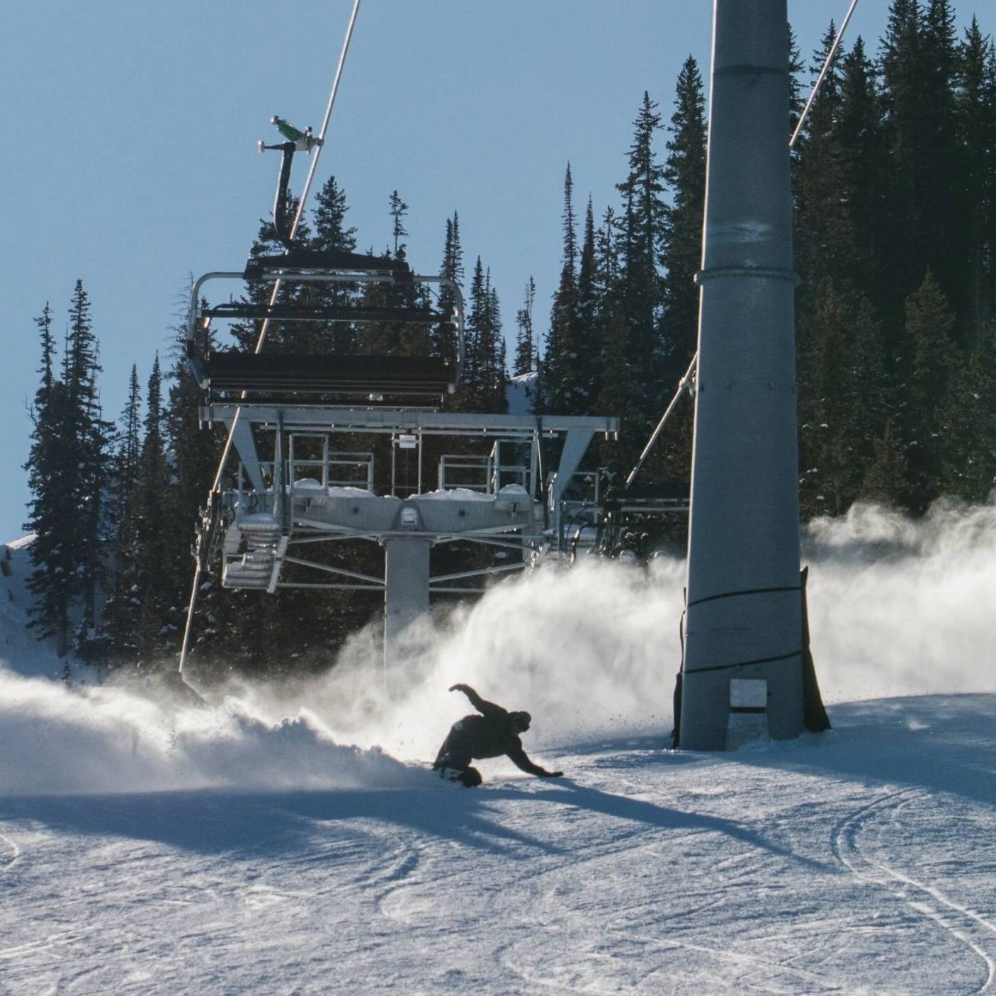 Snowboarder slashing on a groomer at Brighton Ski Resort