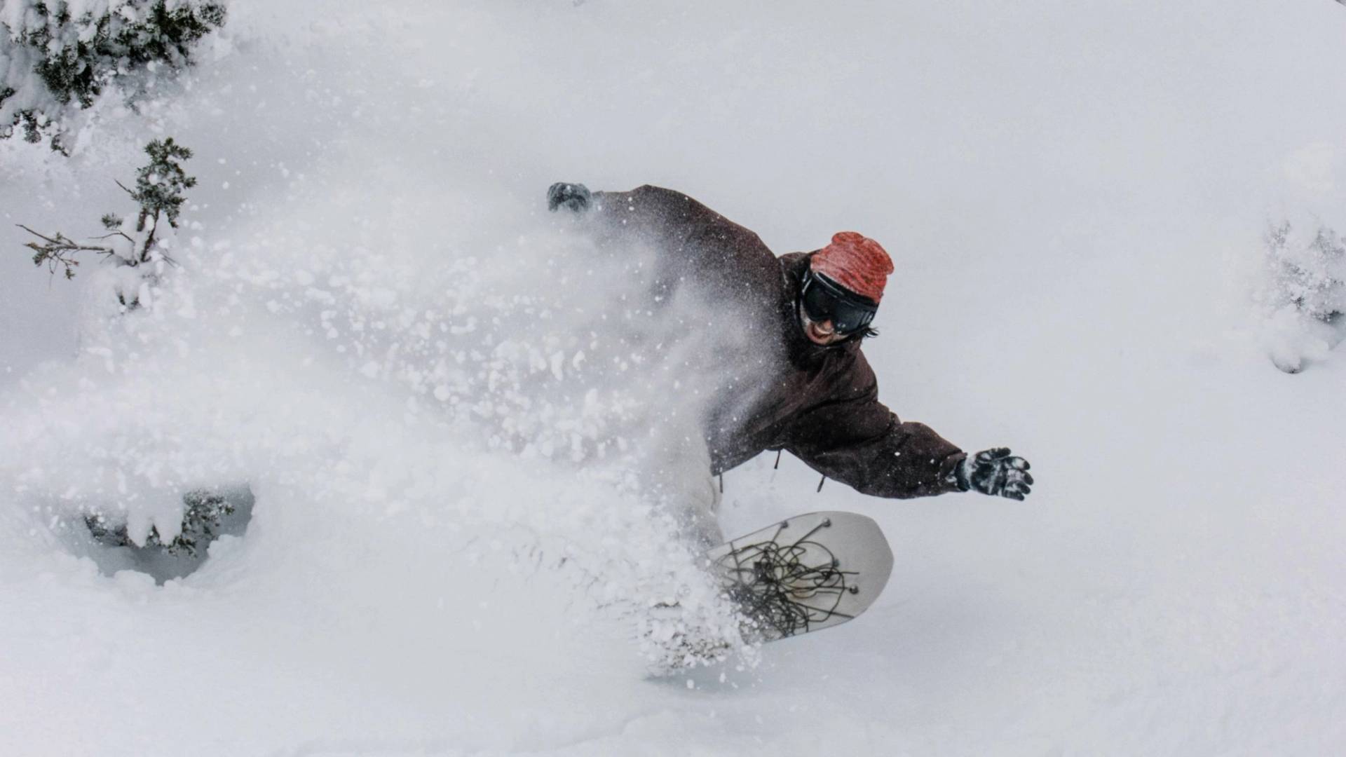 Snowboarder smiling while in deep powder at Brighton Resort