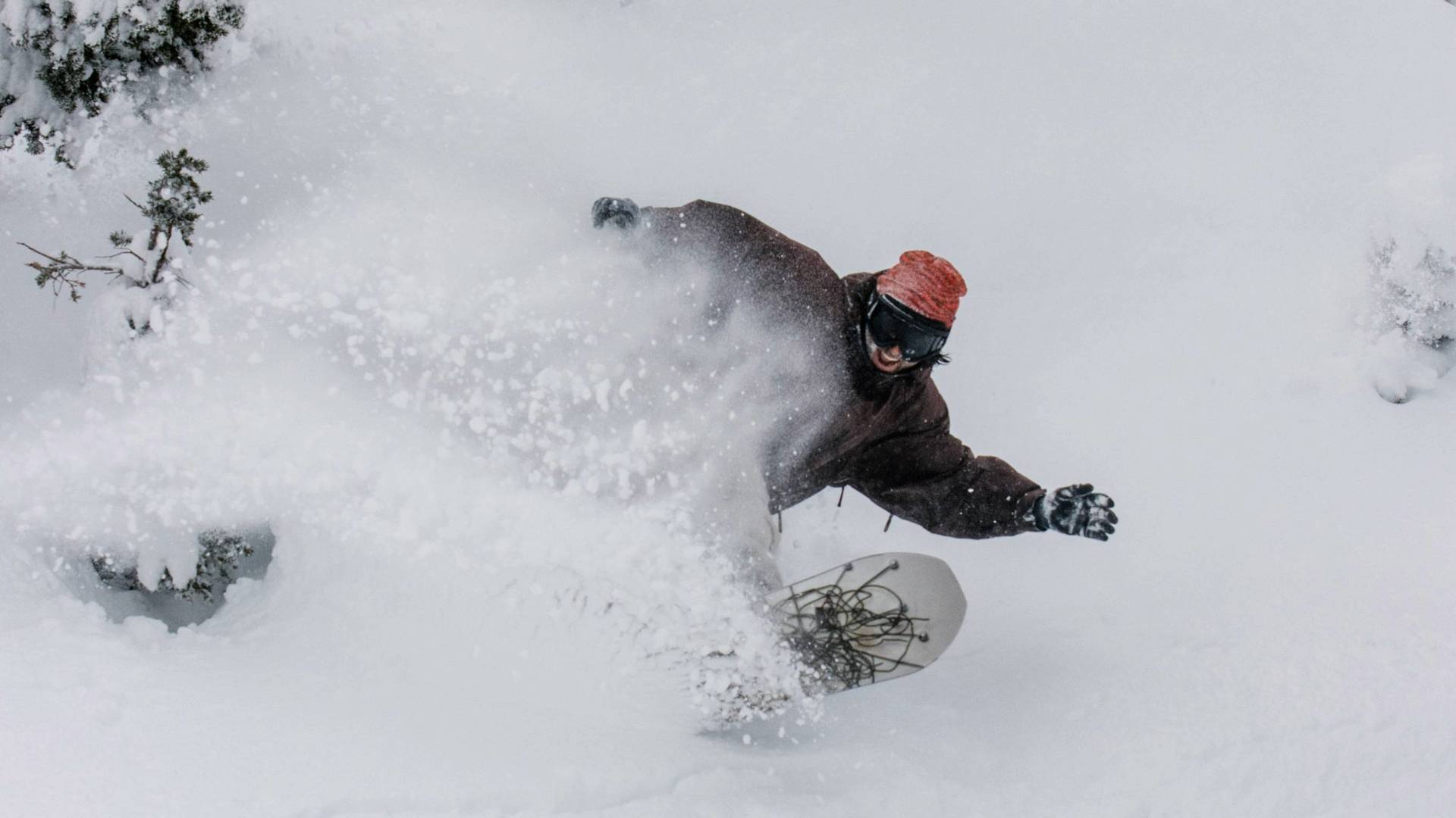 Snowboarder smiling while in deep powder at Brighton Resort