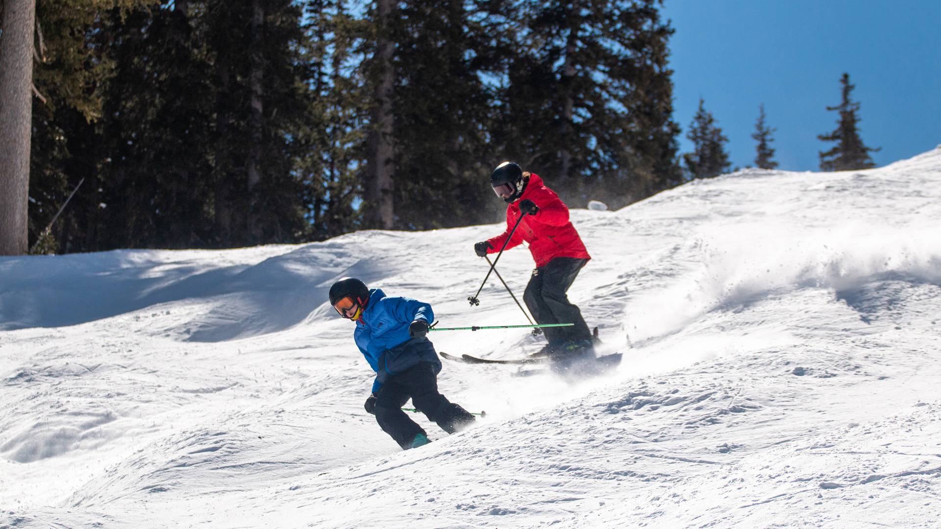 Skier carving with Brighton ski school instructor during lesson