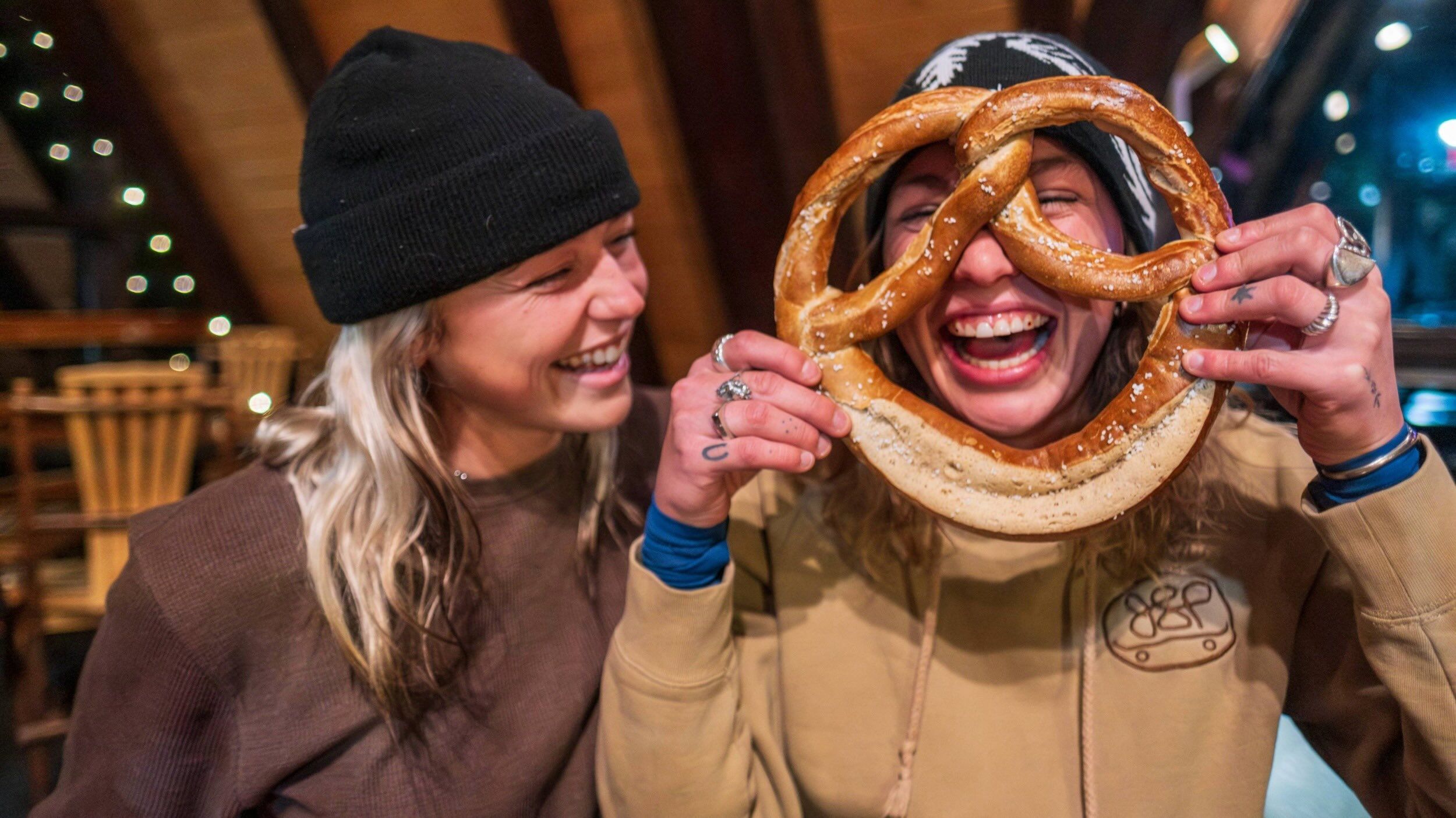 Friends at Molly Green's eating a soft pretzel at Brighton Ski Resort