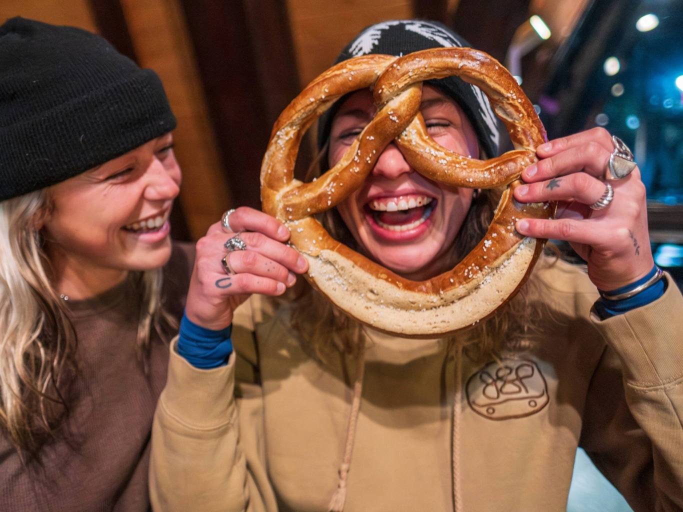 Friends eating a soft pretzel at Molly Green's