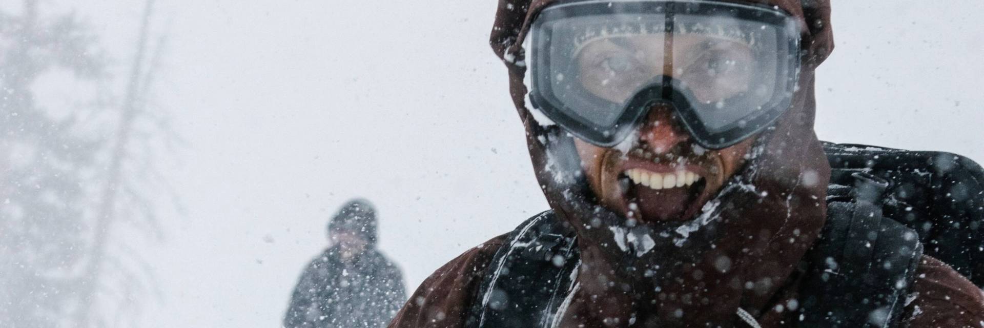 Snowboarder and skier smiling in snow at Brighton Resort