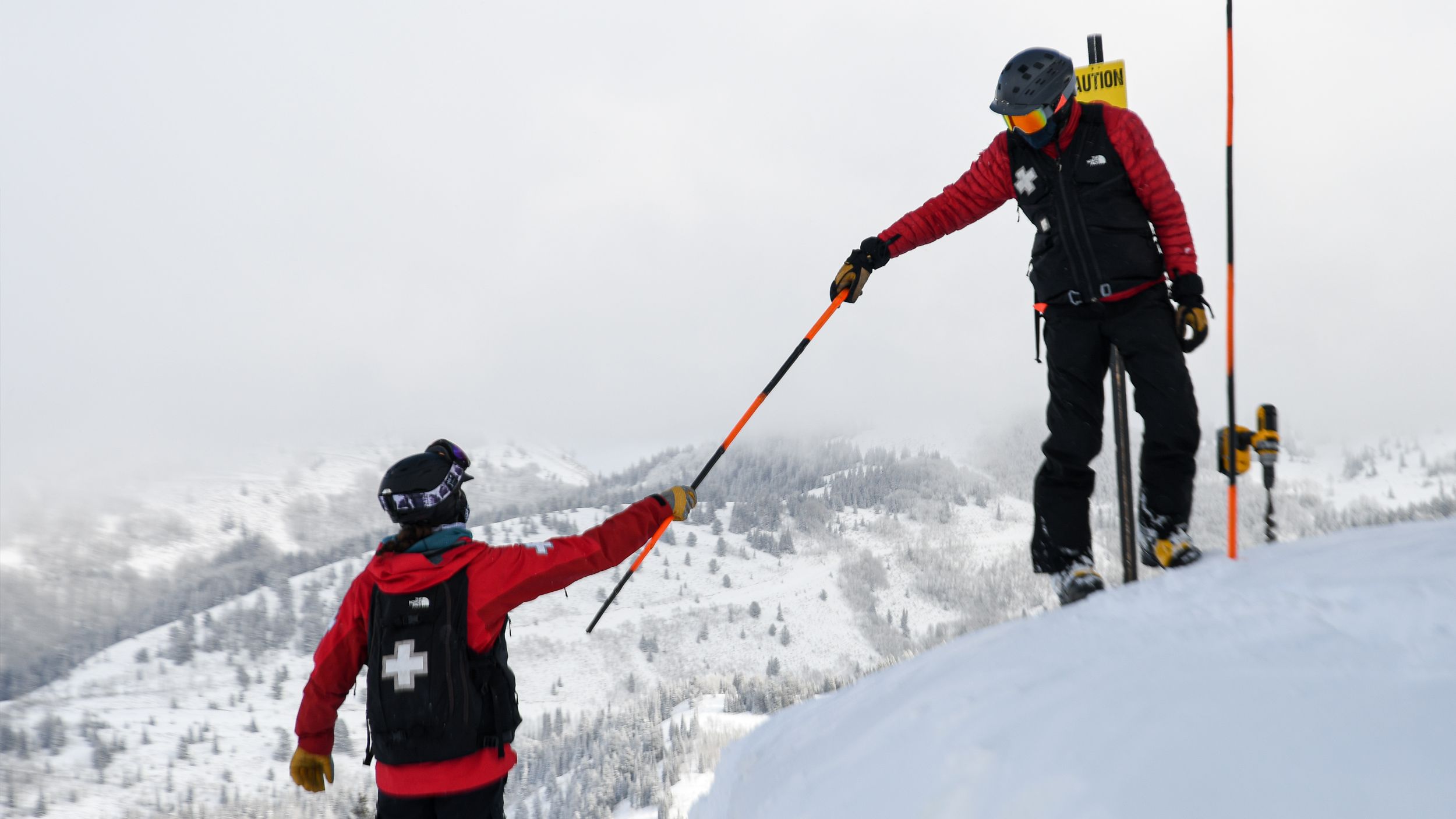 Brighton Ski Patrol helping each other on the mountain