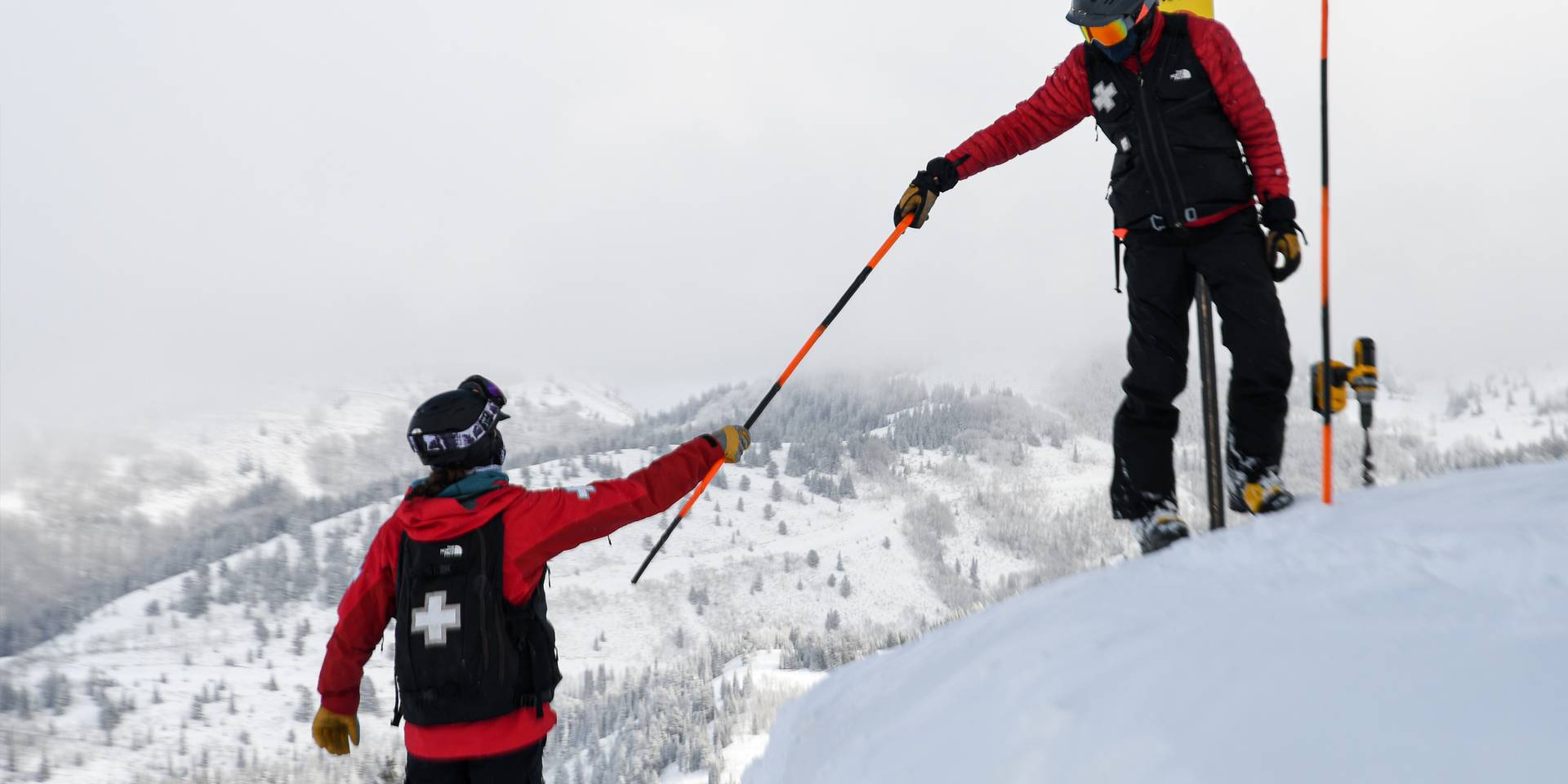 Brighton Ski Patrol helping each other on the mountain