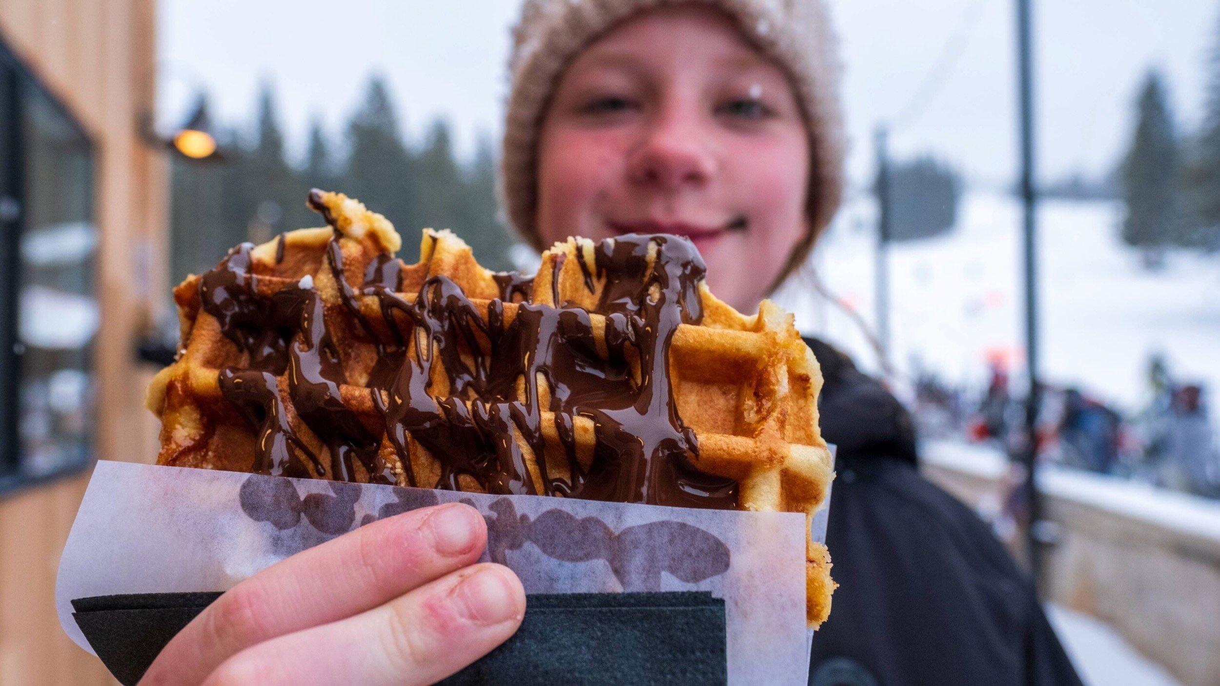 Kid eating at Brighton's Waffle Cabin at the Alpine Rose