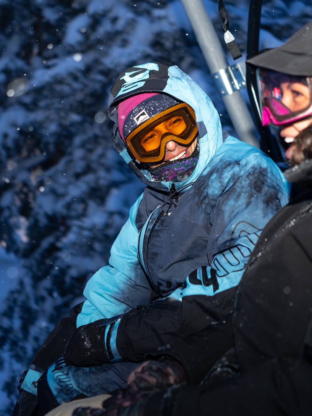 Friends on chair lift night riding