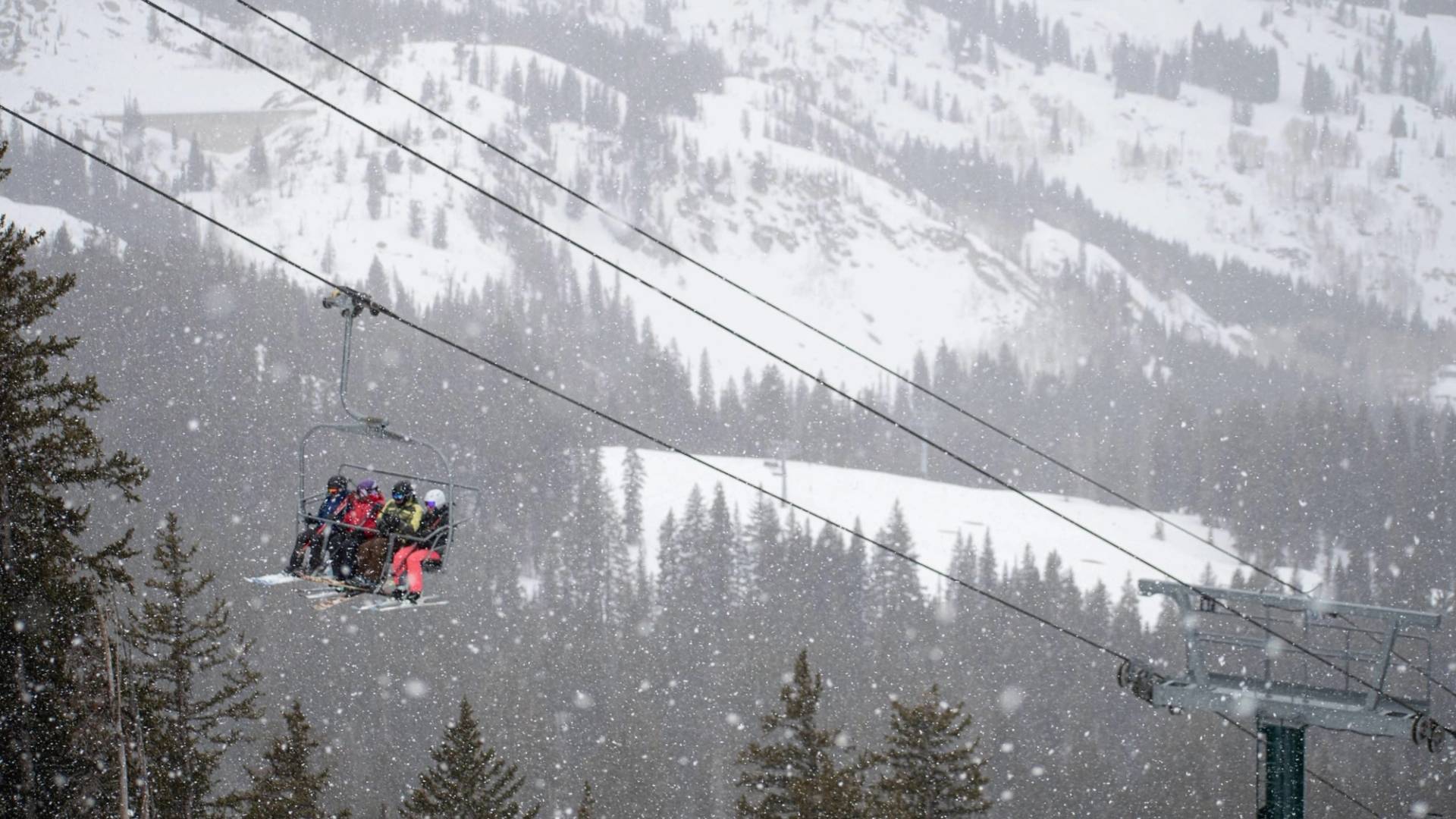 Group of friends on chairlift during a snow day at Brighton Ski Resort