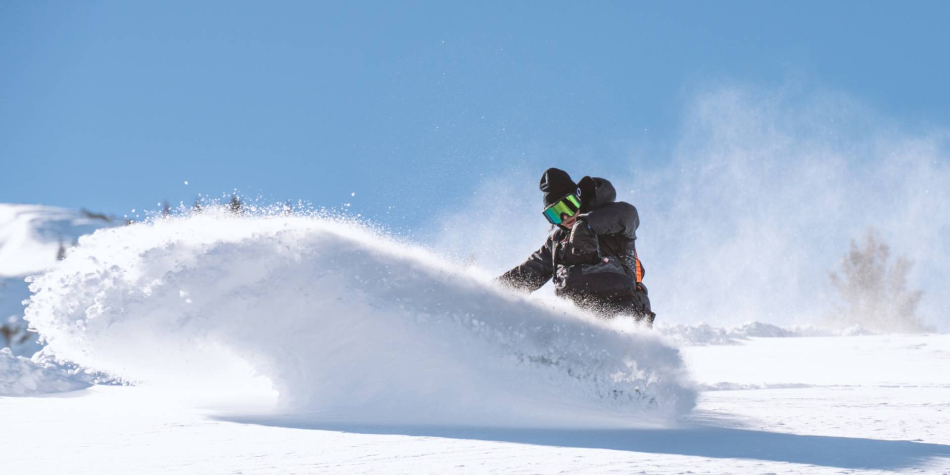 Snowboarder under blue skies at Brighton Resort